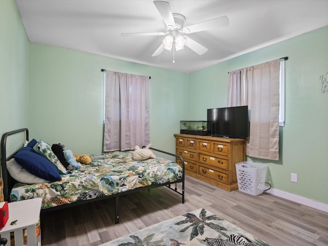 1306 Hulme St, Bowie, TX 76230 - bedroom with baseboards, wood finished floors, and a ceiling fan