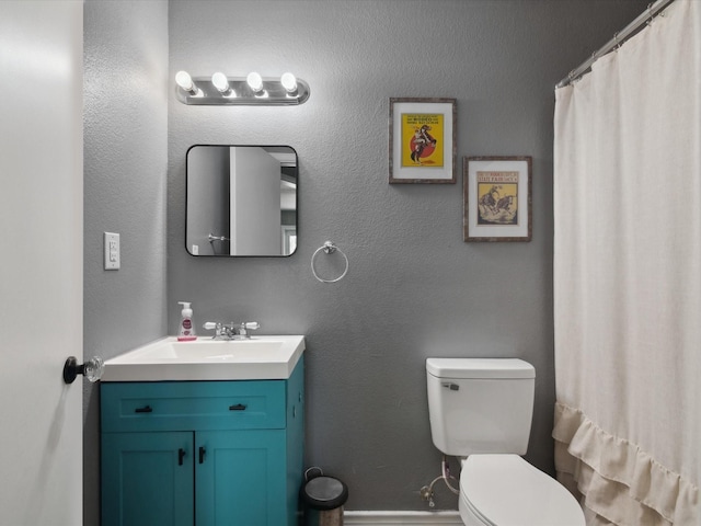 1306 Hulme St, Bowie, TX 76230 - bathroom with a textured wall, toilet, and vanity