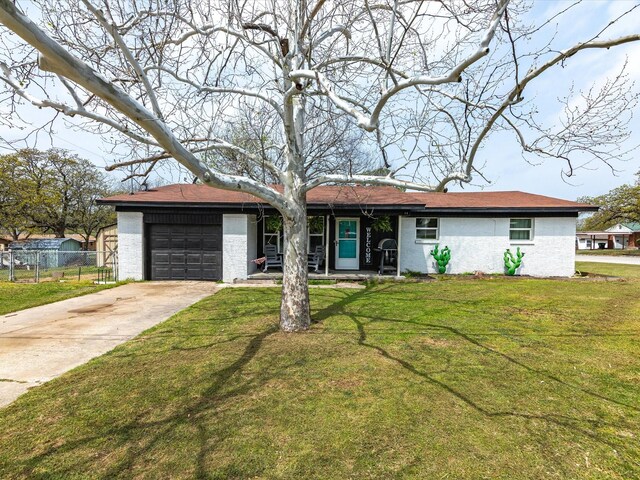 1306 Hulme St, Bowie, TX 76230 - single story home featuring fence, a garage, a front yard, brick siding, and driveway