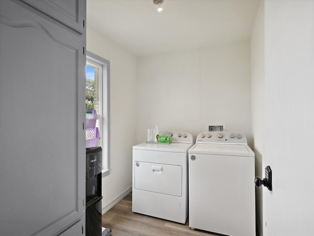 1306 Hulme St, Bowie, TX 76230 - washroom with washer and clothes dryer, light wood-style flooring, and laundry area