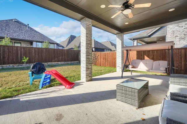 view of patio / terrace with a ceiling fan, a fenced backyard, and outdoor lounge area