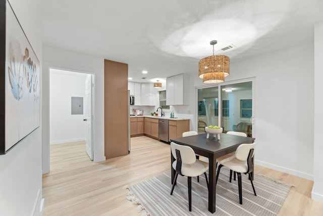 9056 Berkshire Dr, Frisco, TX 75033 - dining space featuring baseboards, light wood-style floors, and electric panel