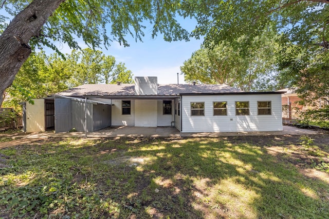 9056 Berkshire Dr, Frisco, TX 75033 - rear view of property with a chimney, a patio, a yard, and roof with shingles