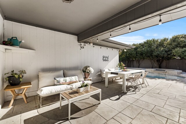 view of patio featuring a fenced backyard and an in ground hot tub