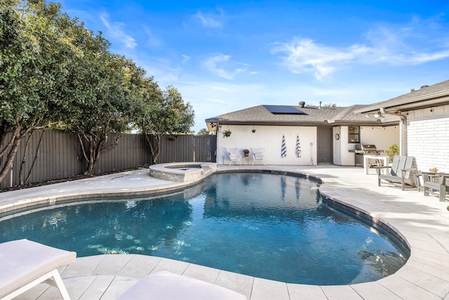 view of pool featuring a fenced backyard, outdoor dining space, a pool with connected hot tub, and a patio