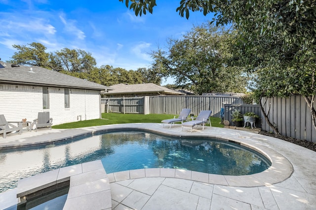 view of swimming pool with a fenced backyard, a fenced in pool, a yard, and a patio