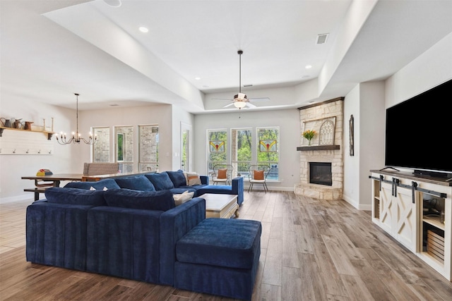 2602 Cypress Dr, Rockwall, TX 75087 - living room featuring baseboards, ceiling fan with notable chandelier, wood finished floors, and a fireplace
