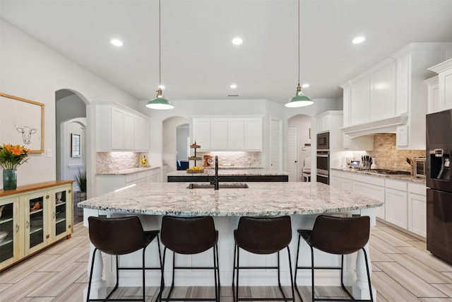 2602 Cypress Dr, Rockwall, TX 75087 - kitchen featuring a sink, decorative backsplash, stainless steel appliances, and an island with sink