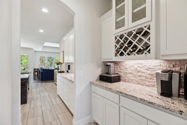 2602 Cypress Dr, Rockwall, TX 75087 - bar featuring recessed lighting, arched walkways, decorative backsplash, and a dry bar