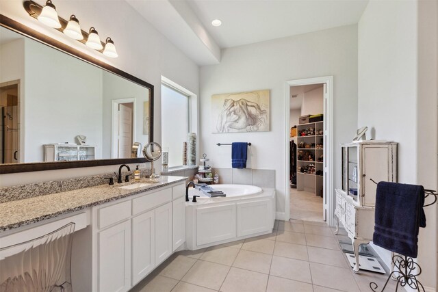 2602 Cypress Dr, Rockwall, TX 75087 - bathroom featuring tile patterned flooring, a bath, a spacious closet, and vanity
