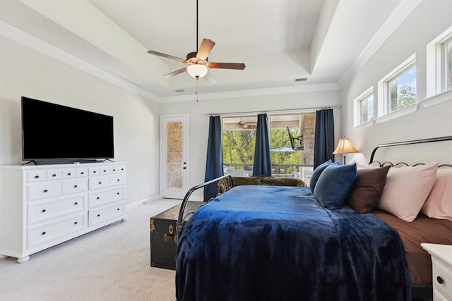 2602 Cypress Dr, Rockwall, TX 75087 - bedroom featuring multiple windows, light carpet, a tray ceiling, and access to outside