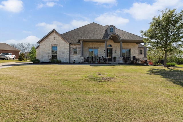 2602 Cypress Dr, Rockwall, TX 75087 - french country home featuring a shingled roof, a front lawn, and stone siding