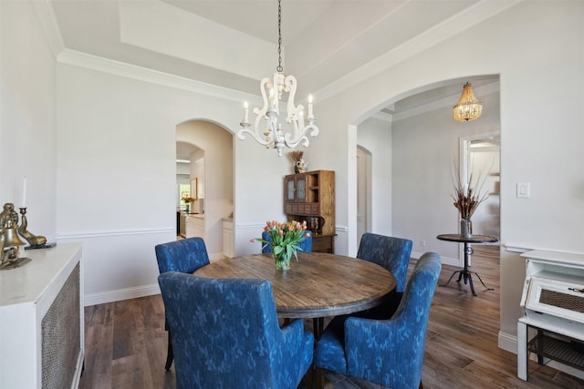 2602 Cypress Dr, Rockwall, TX 75087 - dining area with arched walkways, wood finished floors, and a chandelier