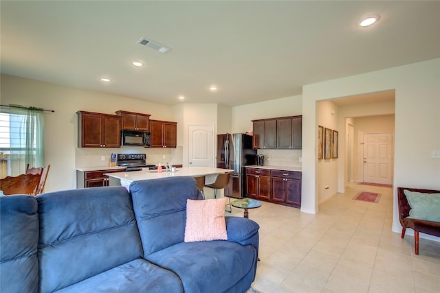 914 Edgar St, Greenville, TX 75401 - living area with recessed lighting, baseboards, light tile patterned flooring, and visible vents