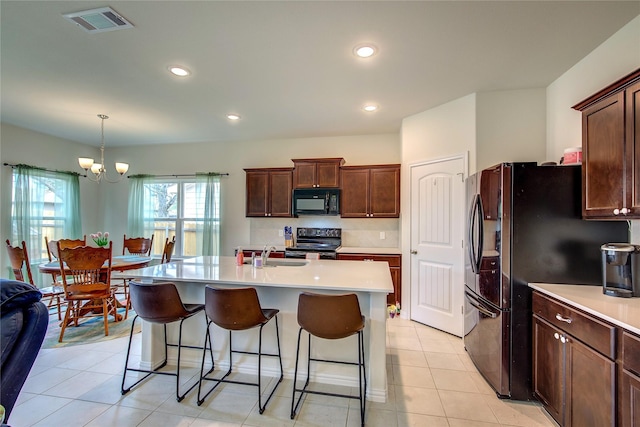 914 Edgar St, Greenville, TX 75401 - kitchen featuring light countertops, visible vents, a chandelier, a sink, and black appliances