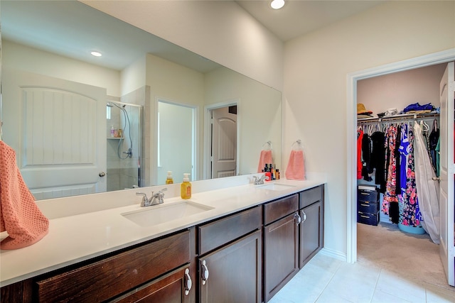 914 Edgar St, Greenville, TX 75401 - bathroom featuring double vanity, a sink, a walk in closet, and a stall shower