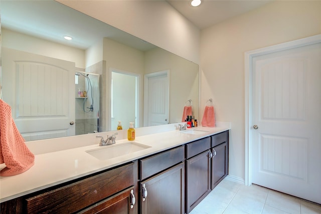 914 Edgar St, Greenville, TX 75401 - bathroom featuring a shower stall, double vanity, tile patterned flooring, and a sink