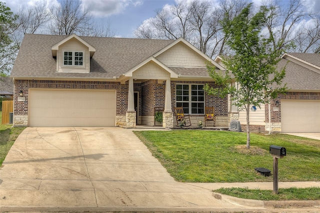 914 Edgar St, Greenville, TX 75401 - craftsman-style home featuring stone siding, a garage, a shingled roof, and a front lawn