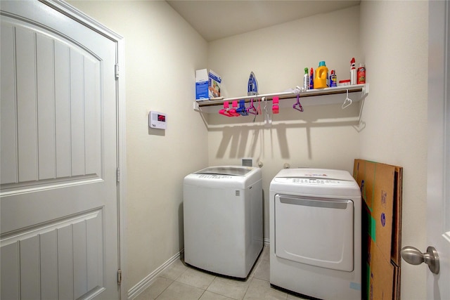 914 Edgar St, Greenville, TX 75401 - laundry area with baseboards, washing machine and dryer, laundry area, and light tile patterned floors