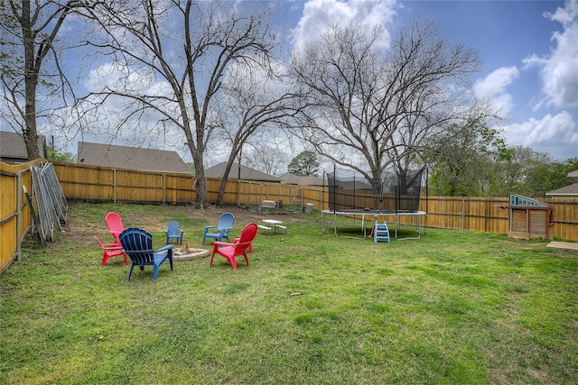 914 Edgar St, Greenville, TX 75401 - view of yard featuring an outdoor fire pit, a fenced backyard, and a trampoline