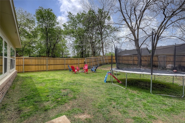 914 Edgar St, Greenville, TX 75401 - view of yard with a trampoline and a fenced backyard