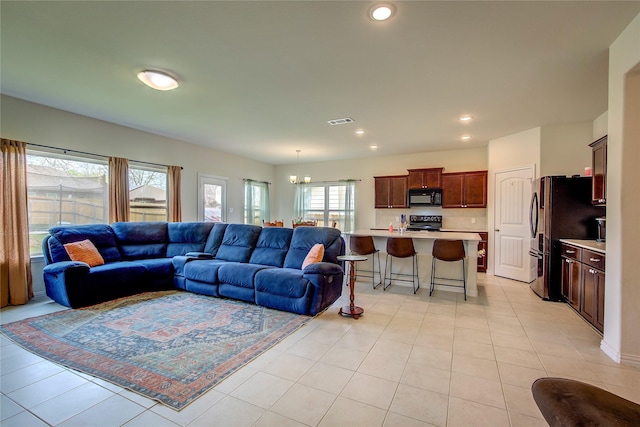 914 Edgar St, Greenville, TX 75401 - living room with visible vents, an inviting chandelier, recessed lighting, and light tile patterned floors