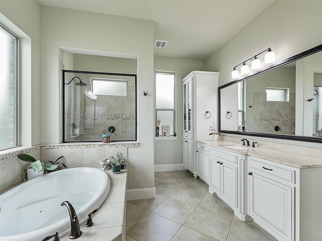 full bath featuring baseboards, vanity, tiled shower, tile patterned flooring, and a garden tub
