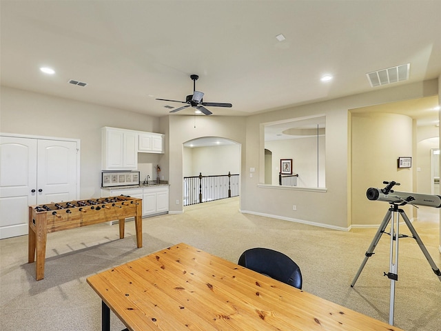 rec room featuring visible vents, recessed lighting, a ceiling fan, and light carpet