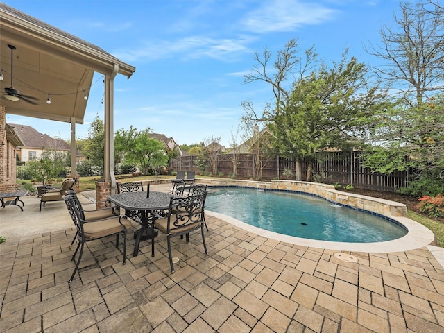 view of pool with a fenced in pool, a patio, a fenced backyard, and a ceiling fan