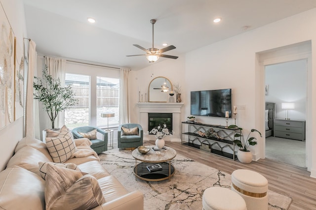 5404 Fairdale Dr, Denton, TX 76207 - living room featuring wood finished floors, a ceiling fan, a glass covered fireplace, recessed lighting, and baseboards