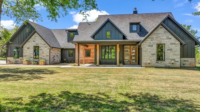 118 E Bay Dr, Bridgeport, TX 76426 - view of front of house featuring a front lawn, roof with shingles, stone siding, and board and batten siding