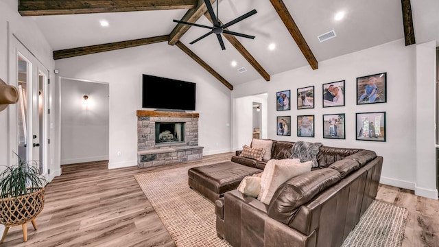 118 E Bay Dr, Bridgeport, TX 76426 - living area featuring visible vents, ceiling fan, light wood-style floors, vaulted ceiling with beams, and a stone fireplace