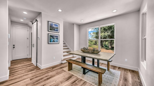 118 E Bay Dr, Bridgeport, TX 76426 - dining area featuring baseboards, a barn door, light wood finished floors, and recessed lighting
