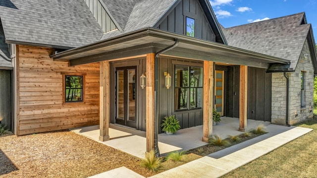 118 E Bay Dr, Bridgeport, TX 76426 - doorway to property featuring roof with shingles, board and batten siding, and covered porch