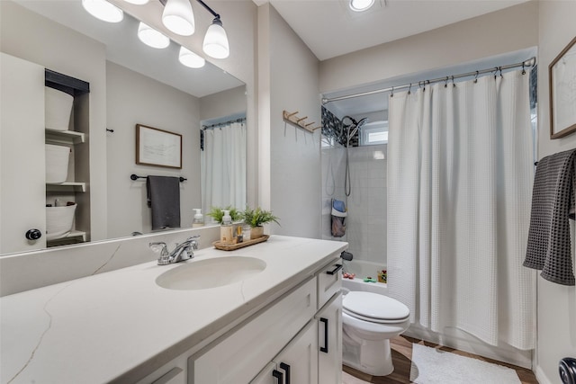 full bath featuring shower / tub combo with curtain, toilet, vanity, and wood finished floors