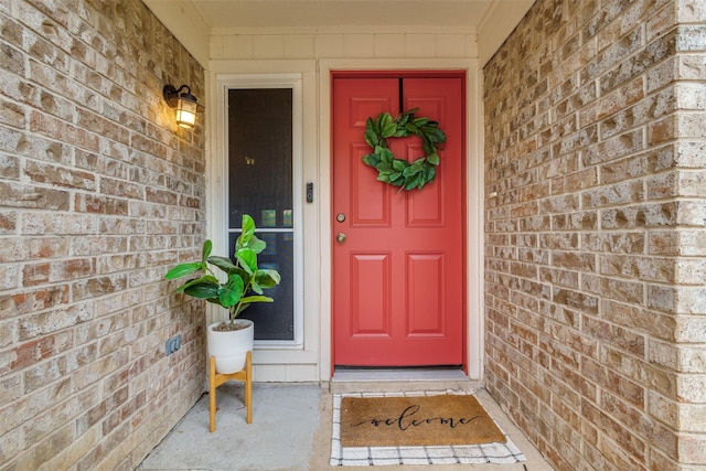 view of exterior entry with brick siding