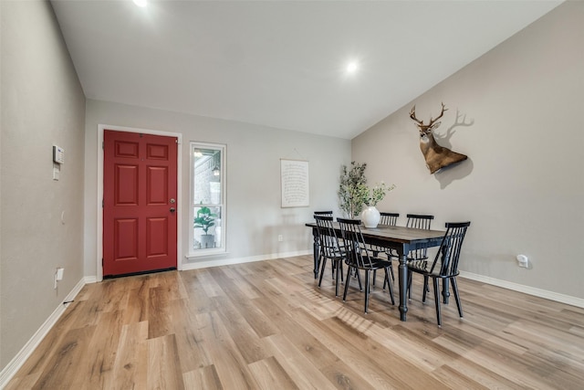 dining room featuring baseboards and light wood-style flooring