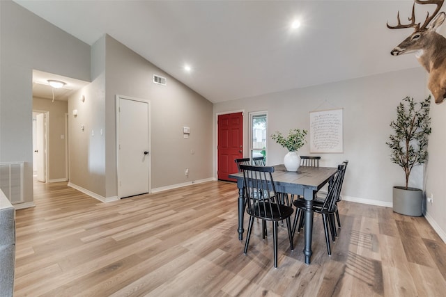 dining area featuring baseboards, light wood-style flooring, and visible vents