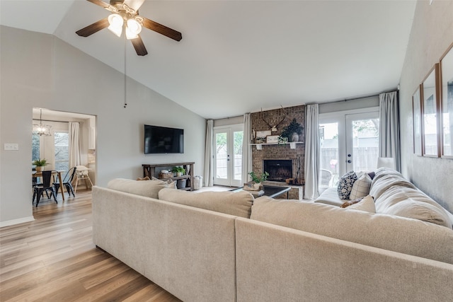 living area with plenty of natural light, a brick fireplace, and light wood finished floors