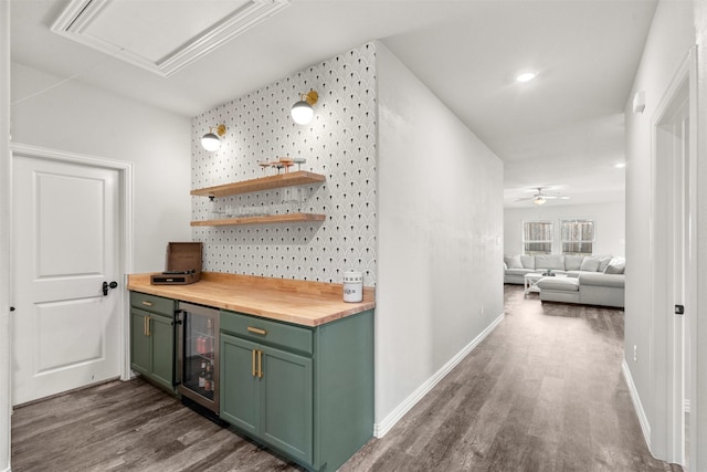 hallway featuring dark wood-type flooring, baseboards, and beverage cooler