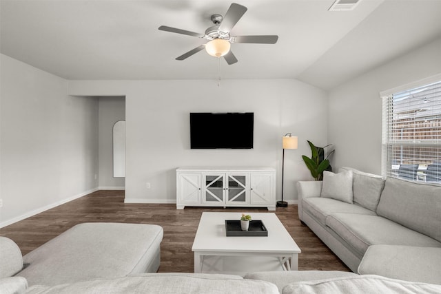 living area featuring dark wood finished floors, baseboards, vaulted ceiling, and ceiling fan