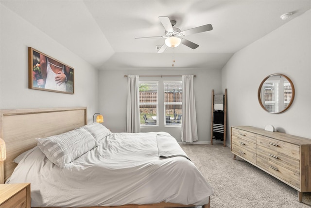 bedroom featuring light carpet, lofted ceiling, and ceiling fan