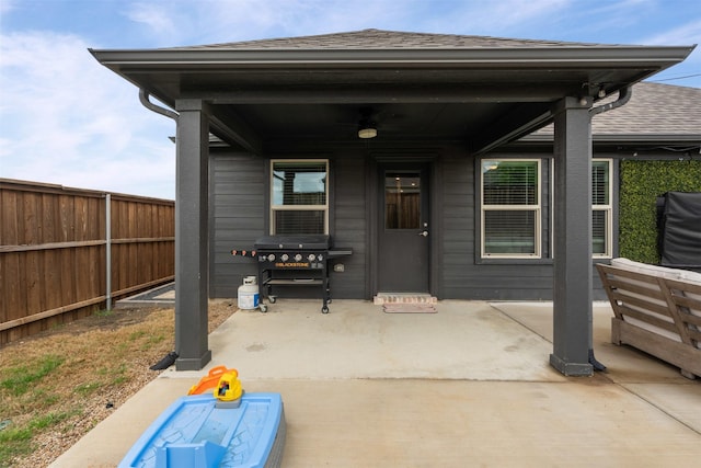 view of patio featuring ceiling fan, area for grilling, and fence