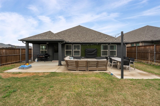rear view of house featuring an outdoor living space, a shingled roof, a patio area, and a lawn