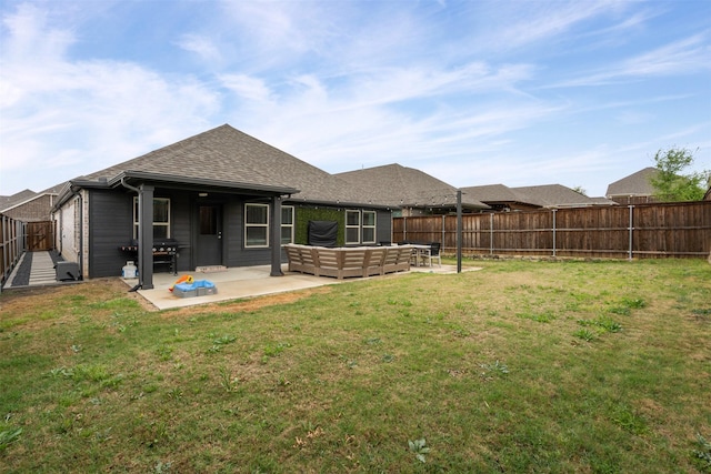 back of house featuring a patio, a fenced backyard, and a lawn