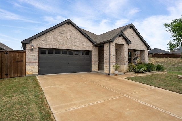 view of front facade featuring fence, driveway, an attached garage, and brick siding