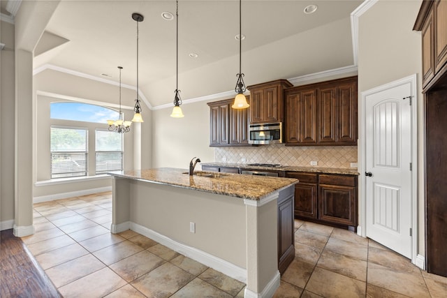 612 Buelwood Ct, Desoto, TX 75115 - kitchen featuring stainless steel appliances, a sink, decorative backsplash, light stone counters, and a kitchen island with sink