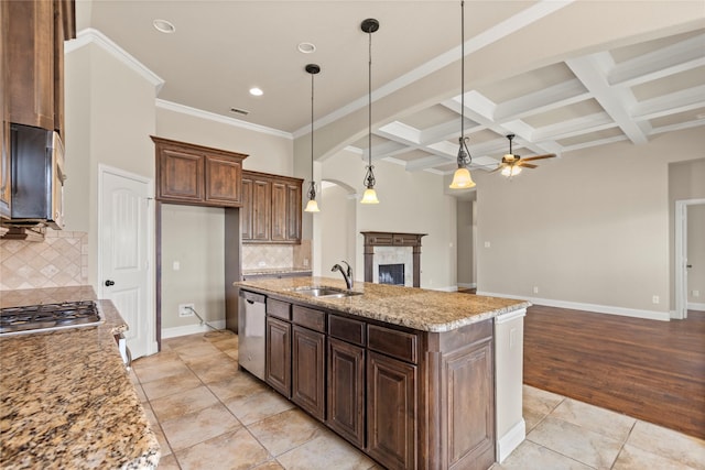 612 Buelwood Ct, Desoto, TX 75115 - kitchen featuring a sink, stainless steel appliances, a ceiling fan, beam ceiling, and a fireplace