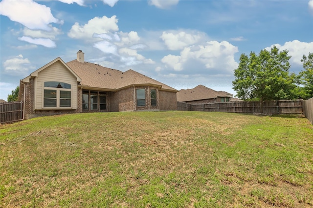 612 Buelwood Ct, Desoto, TX 75115 - back of property featuring brick siding, a fenced backyard, and a chimney