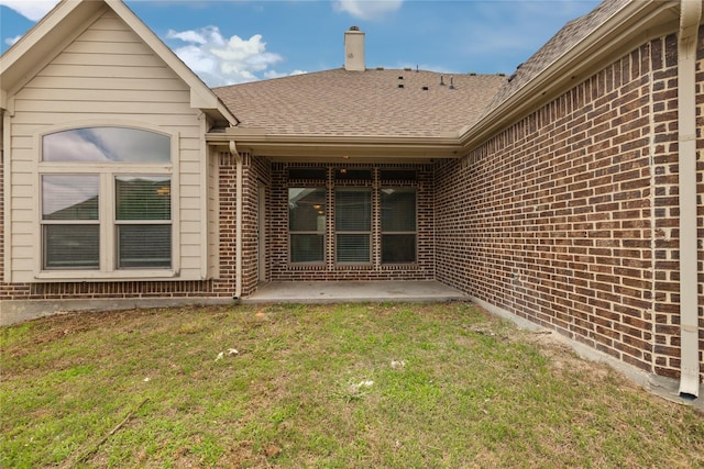 612 Buelwood Ct, Desoto, TX 75115 - back of house featuring brick siding, roof with shingles, a yard, and a patio